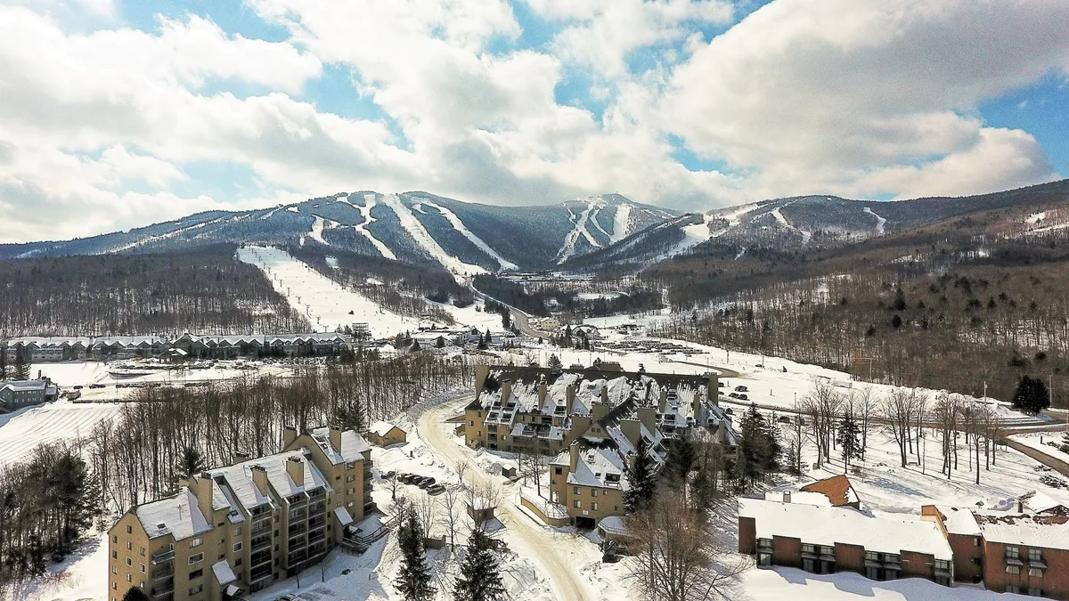 A wide view of snow-covered mountains, ski slopes, and residential buildings, with an inviting lodge atmosphere. This image sets the context of the Killington area, highlighting the energy of the mountain and proximity to ski resorts, restaurants, and nightlife.