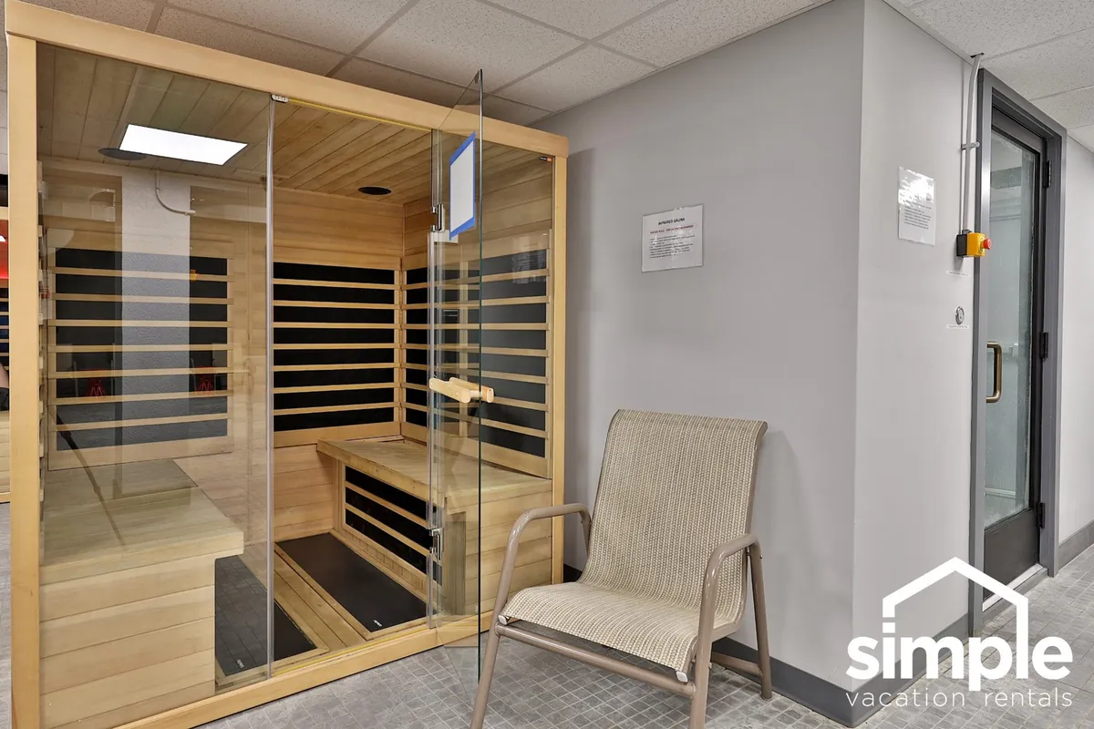 An inviting interior shot of a sauna with wooden seating and a tranquil atmosphere. The setup suggests relaxation and wellness after a day of mountain activities, closely aligning with the section’s mention of winding down in the onsite sauna or steam room.
